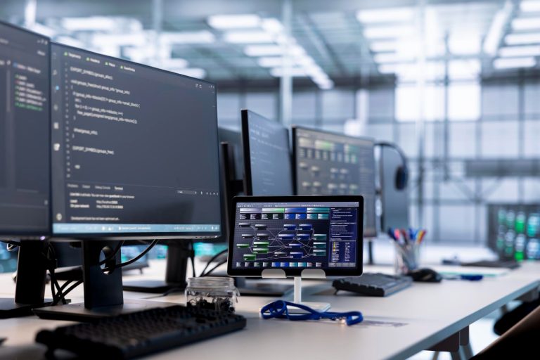 IT support professionals working in a bright modern Salt Lake City office monitoring secure server backup disaster recovery dashboards.
